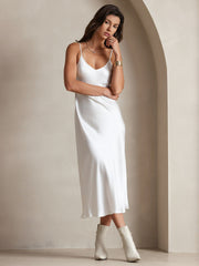 White 100% Mulberry Silk Spaghetti Strap V Neck Midi Dress on a woman, styled with white boots.