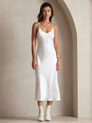 White mulberry silk spaghetti strap V-neck midi dress on a woman.