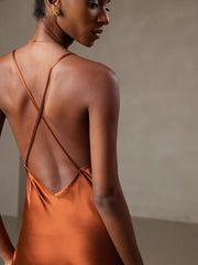 Caramel mulberry silk midi dress with spaghetti straps and criss-cross back design.