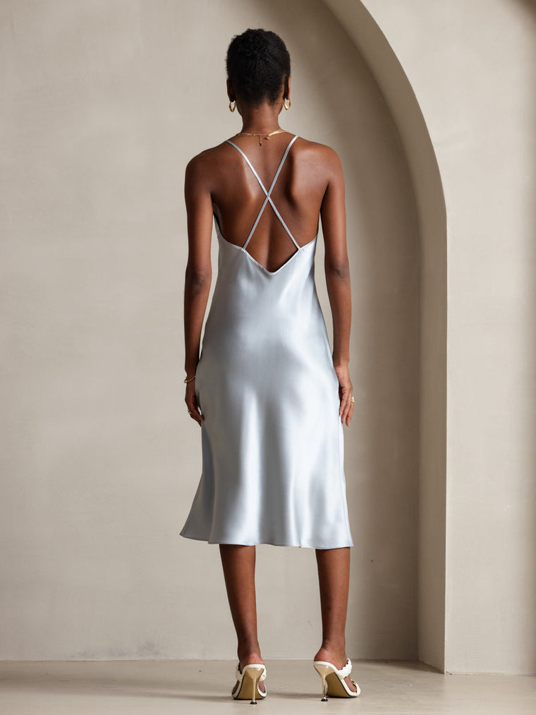 Light blue mulberry silk midi dress with spaghetti straps and criss-cross back design.