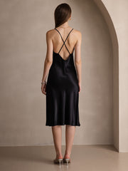 Black mulberry silk midi dress with spaghetti straps and criss-cross back design.