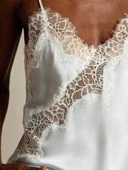 Light blue mulberry silk camisole top with delicate white lace trim and spaghetti straps.