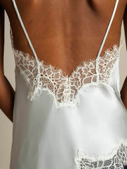 Women's light blue mulberry silk camisole top with spaghetti straps and white lace trim on the back.