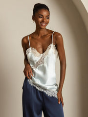 White mulberry silk camisole top with lace trim, spaghetti straps, and asymmetrical hem.