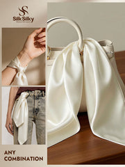 Ivory 100% Mulberry silk square scarf styled on a handbag, wrist, and jeans.