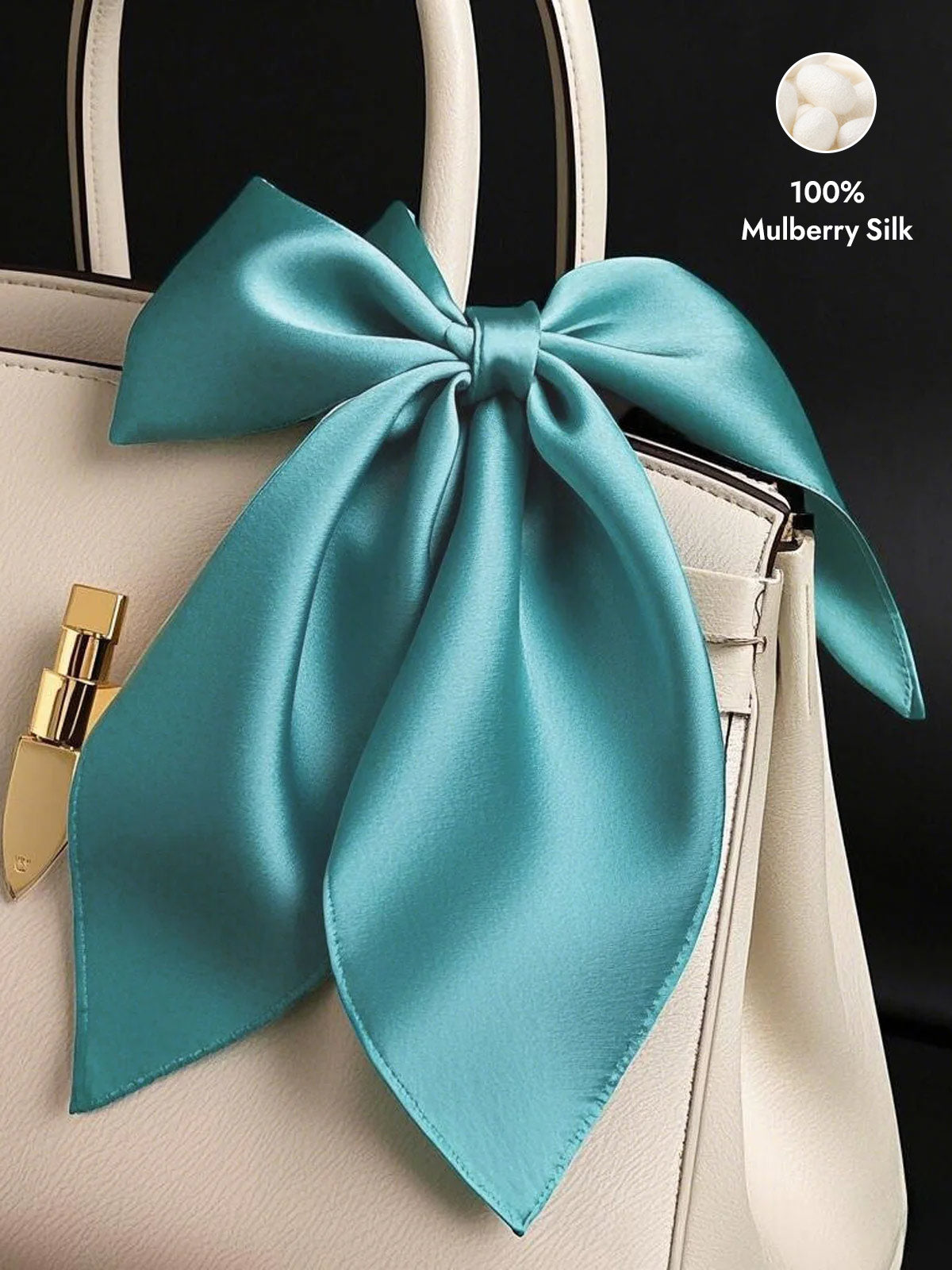 Teal 100% Mulberry Silk Square Scarf tied as a bow on a cream handbag.