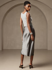 Woman in a gray mulberry silk stretch long straight skirt and light gray top.