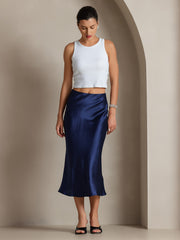 Woman in a navy blue 100% Mulberry silk stretch long straight skirt and white tank top.