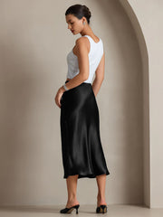 Woman in black mulberry silk stretch long straight skirt and white top.