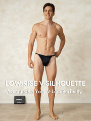 Smiling man models black mulberry silk string men's underwear with a low-rise V-silhouette.