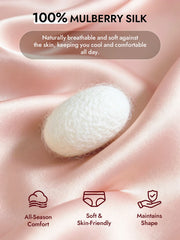 White mulberry silk cocoon on soft pink silk fabric, highlighting natural breathability and comfort.