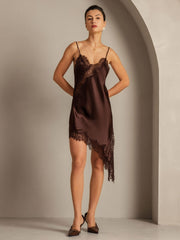 Women's mulberry silk slip dress in brown with V-neck, lace trim, and asymmetrical hem.