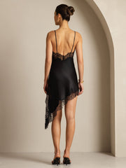 Black mulberry silk slip dress with V-neck, asymmetrical hem, and delicate lace trim.