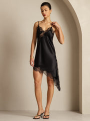Black mulberry silk slip dress with V-neck, lace design, and asymmetrical hem.