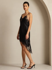 Black mulberry silk V-neck slip dress with lace trim and asymmetrical hem.