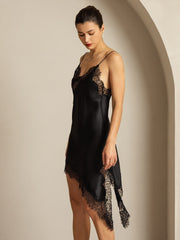 Black mulberry silk V-neck slip dress with lace trim and asymmetrical hem.