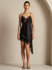 Black mulberry silk V-neck slip dress with asymmetrical lace hem.