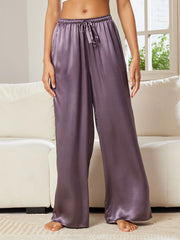 Women's mulberry silk wide-leg pants in a soft purple color with a drawstring waist.