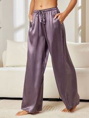 Women's purple gray mulberry silk wide leg pants with drawstring waist and pockets.