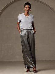 Women's grey mulberry silk wide-leg pants with elastic waist and drawstring, paired with a light grey silk top.