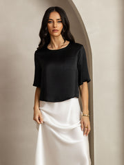 Women's black mulberry silk short sleeve boxy crop top with pocket, paired with a white silk skirt.