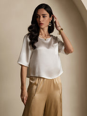 Women's white mulberry silk short sleeve boxy crop top with pocket, paired with gold silk pants.