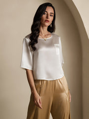 Women's white mulberry silk short sleeve boxy crop top with pocket, paired with gold silk pants.