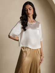 Women's white mulberry silk short sleeve boxy crop top with pocket, paired with gold silk pants.