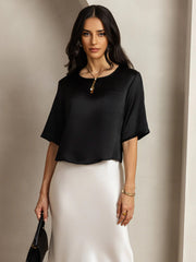 Black mulberry silk women's short sleeve boxy crop top with pocket, paired with a white skirt.