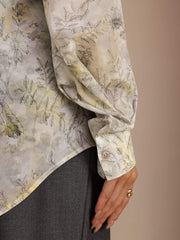 Mulberry silk women's lapel collar blouse with a subtle floral print and long sleeves.