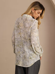Women's mulberry silk lapel collar blouse with a subtle green and grey leaf print, long sleeves.