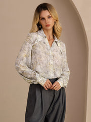 Women's mulberry silk lapel collar blouse with a subtle floral print, long sleeves, and button-front closure.
