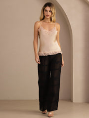 Women's champagne mulberry silk camisole top with V-neck and pink lace trim, paired with black sheer pants.