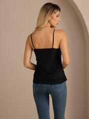 Woman in black mulberry silk spaghetti strap camisole with lace trim, paired with blue jeans.