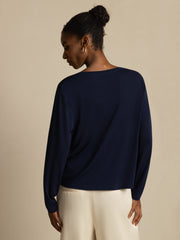 Women's navy blue mulberry silk long-sleeve V-neck top with a relaxed fit.