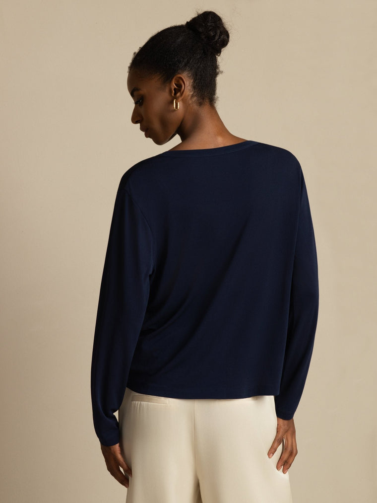 Women's navy blue mulberry silk long-sleeve V-neck top with a relaxed fit.