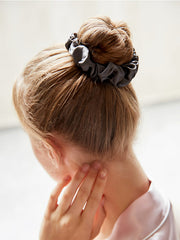 Charcoal gray 16 Momme pure mulberry silk scrunchie on a blonde bun, soft classic hair accessory.