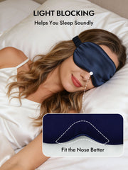 Woman sleeping soundly wearing a navy blue mulberry silk sleep eye mask with an elastic band and nose fit design.