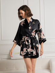 Women's black 19 Momme mulberry silk kimono robe with crane print, 3/4 sleeves, and tie waist.