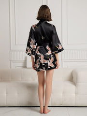 Women's black 19Momme mulberry silk kimono robe with crane print, 3/4 sleeves, and wrap design.