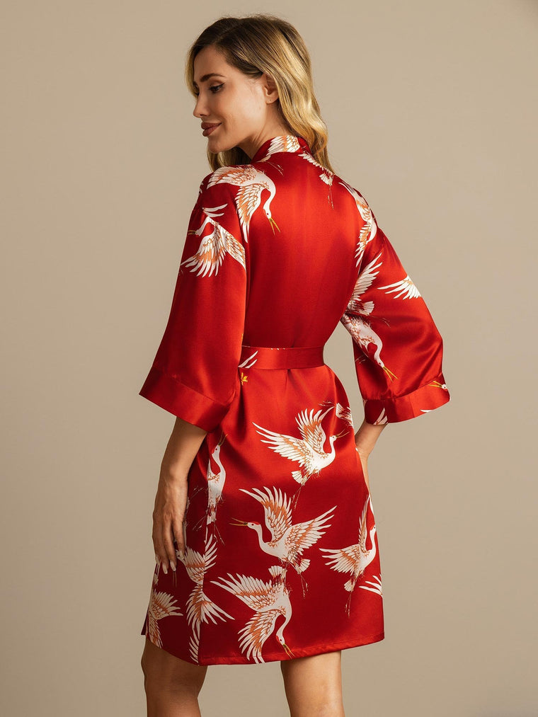Women's red mulberry silk kimono robe with white crane print and belt.