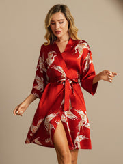 Women's red 19Momme mulberry silk kimono robe with white crane print and belted wrap style.