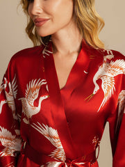 Women's red mulberry silk kimono robe with white crane print and belted wrap style.