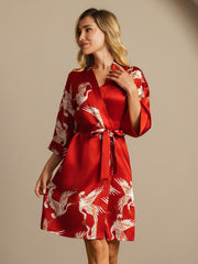 Women's red mulberry silk kimono robe with white crane print and belted wrap style.