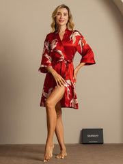 Women's red 19 Momme mulberry silk kimono robe with white crane print and belted wrap style.