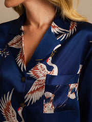 Women's navy mulberry silk nightshirt with white and orange crane print, collar, and front pocket.