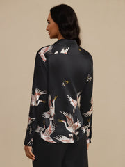 Women's black 19 Momme mulberry silk long sleeve blouse with lapel collar and crane print.