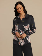 Women's black 19 Momme mulberry silk long sleeve blouse with lapel collar and crane print.