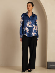 Women's mulberry silk long sleeve blouse in blue with a crane print, lapel collar, and buttons.