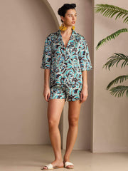 Women's mulberry silk botanical print short sleeve button-up pajama set in teal, black, and white.